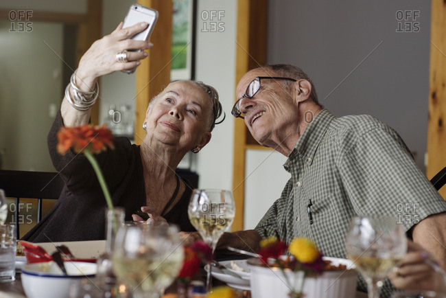 Senior couple taking selfie at Thanksgiving dinner