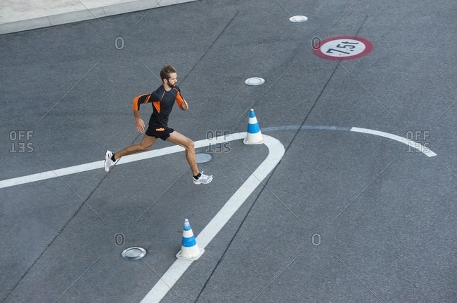 Man running on street with markings