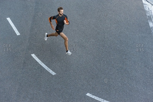 Man running on street with markings