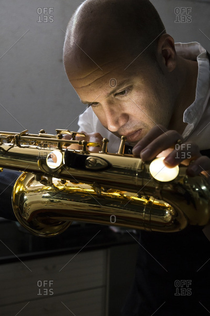 Instrument maker repairing a saxophone