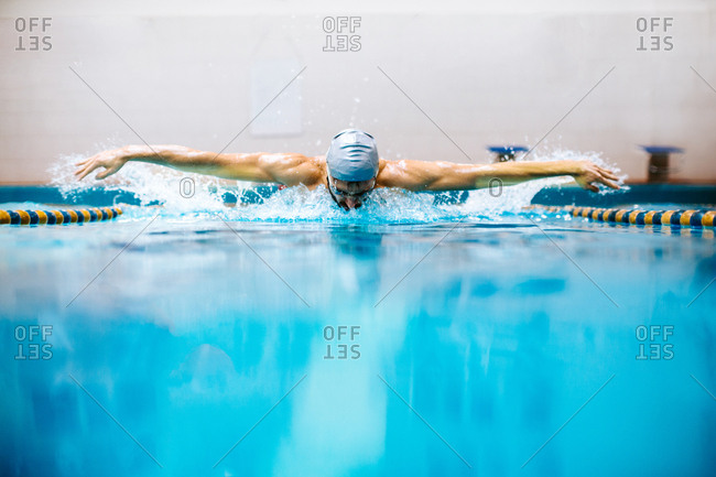 Man in swimming pool doing butterfly stroke