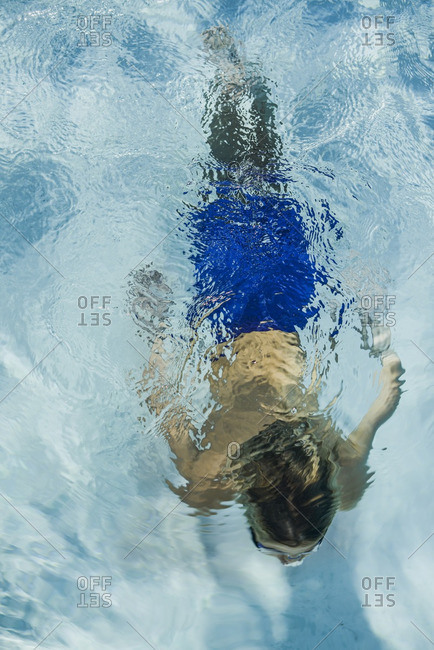 Overhead view of a boy swimming in a pool