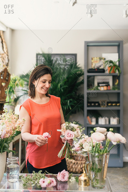 Florist arranging bouquet in flower shop