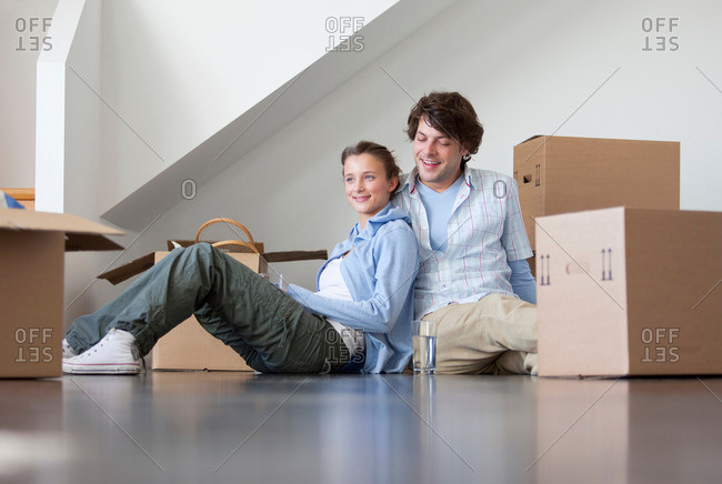 Couple sitting with cardboard boxes