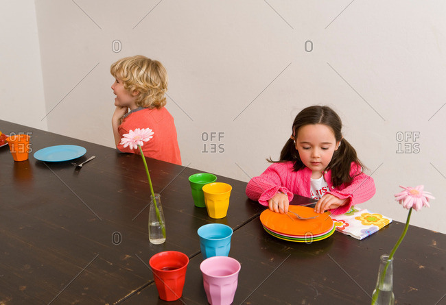 Children playing at table in kitchen