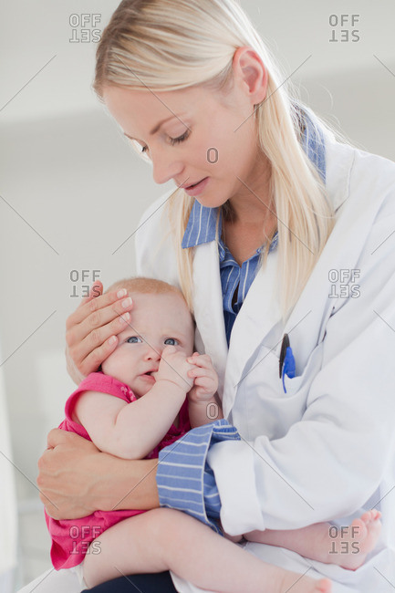 Doctor hugging crying baby