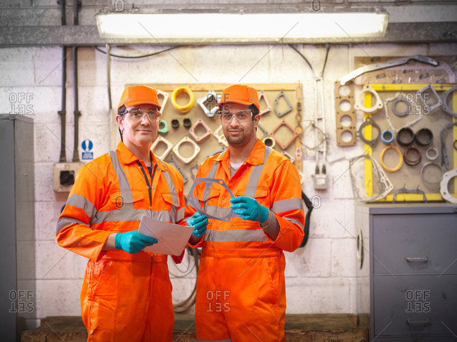 Engineers holding engine parts