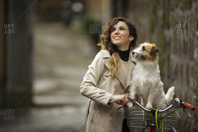 Young woman exploring by bike with her dog.