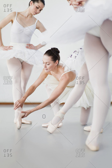 Ballet dancer adjusting colleagues pose