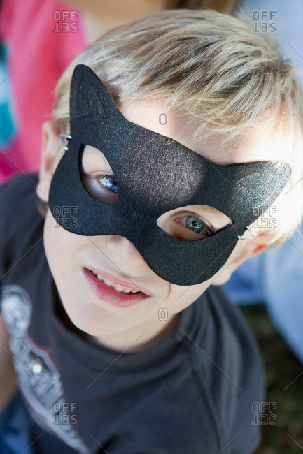 Close up of boy wearing cat mask