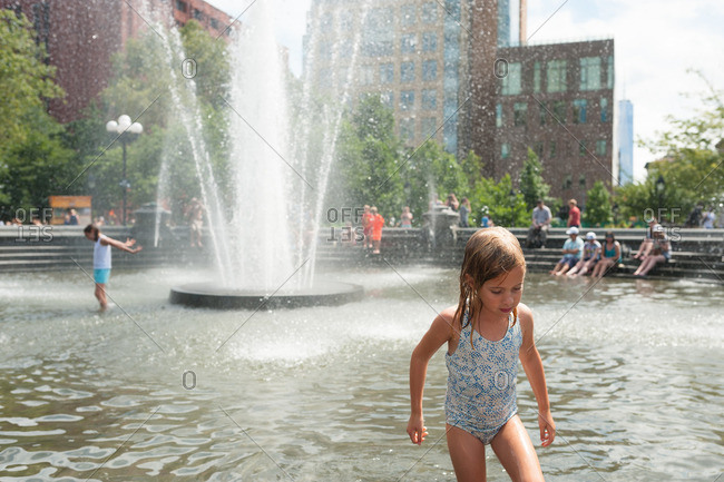 Girl walking out of water fountain