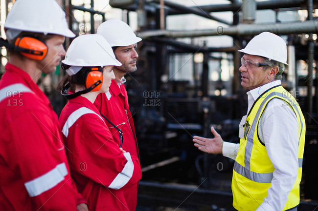 Workers talking at chemical plant