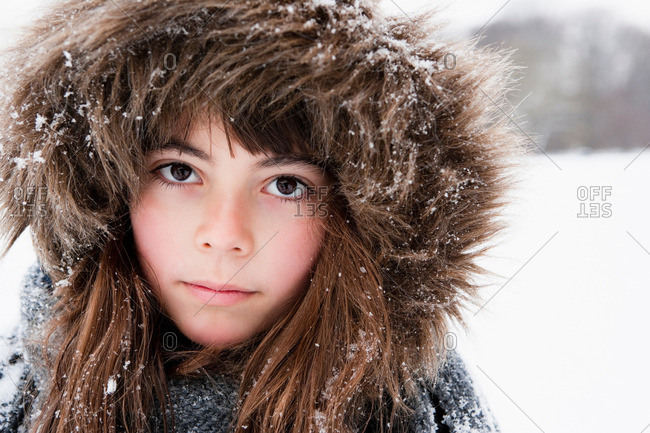 Girl with fur cap looking to camera