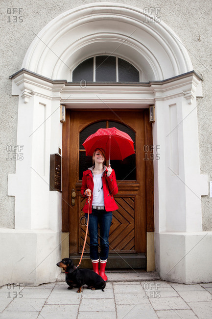 Woman with umbrella and sausage dog
