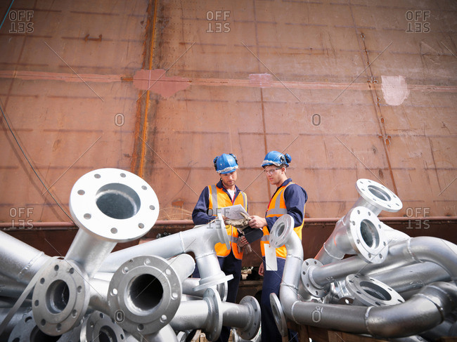Engineers inspecting ship parts