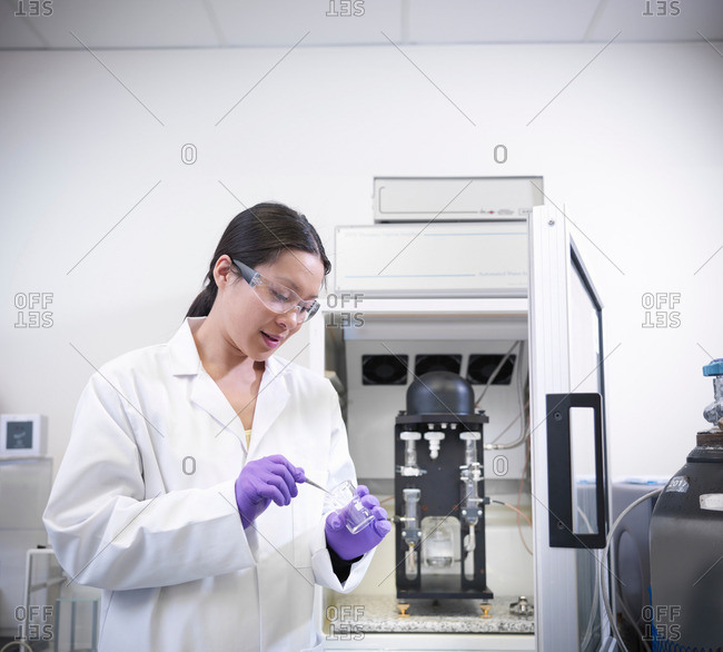 Scientist in laboratory with analytical scientific equipment