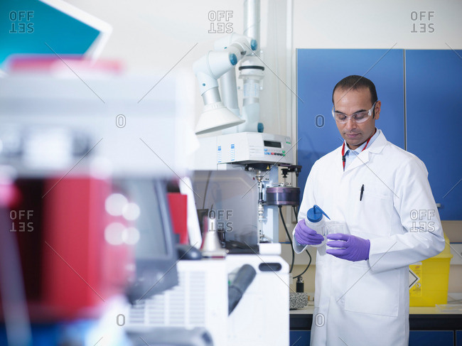 Scientist in laboratory with analytical scientific equipment