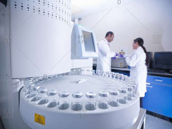 Scientists in laboratory with analytical scientific equipment