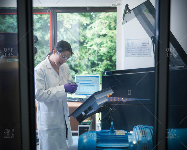 Scientist in laboratory with samples and analytical scientific equipment