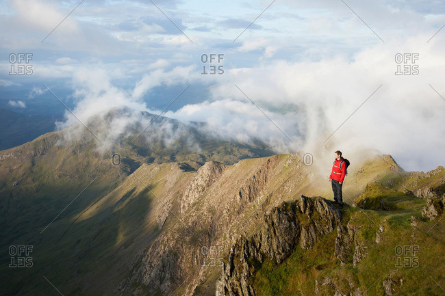 Hiker overlooking view from mountaintop