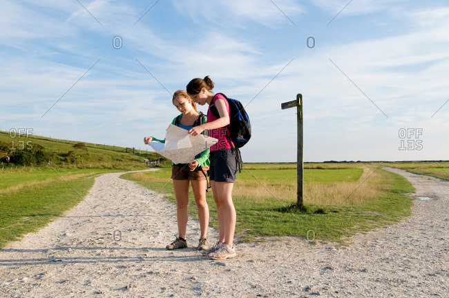 Female hikers check route on map