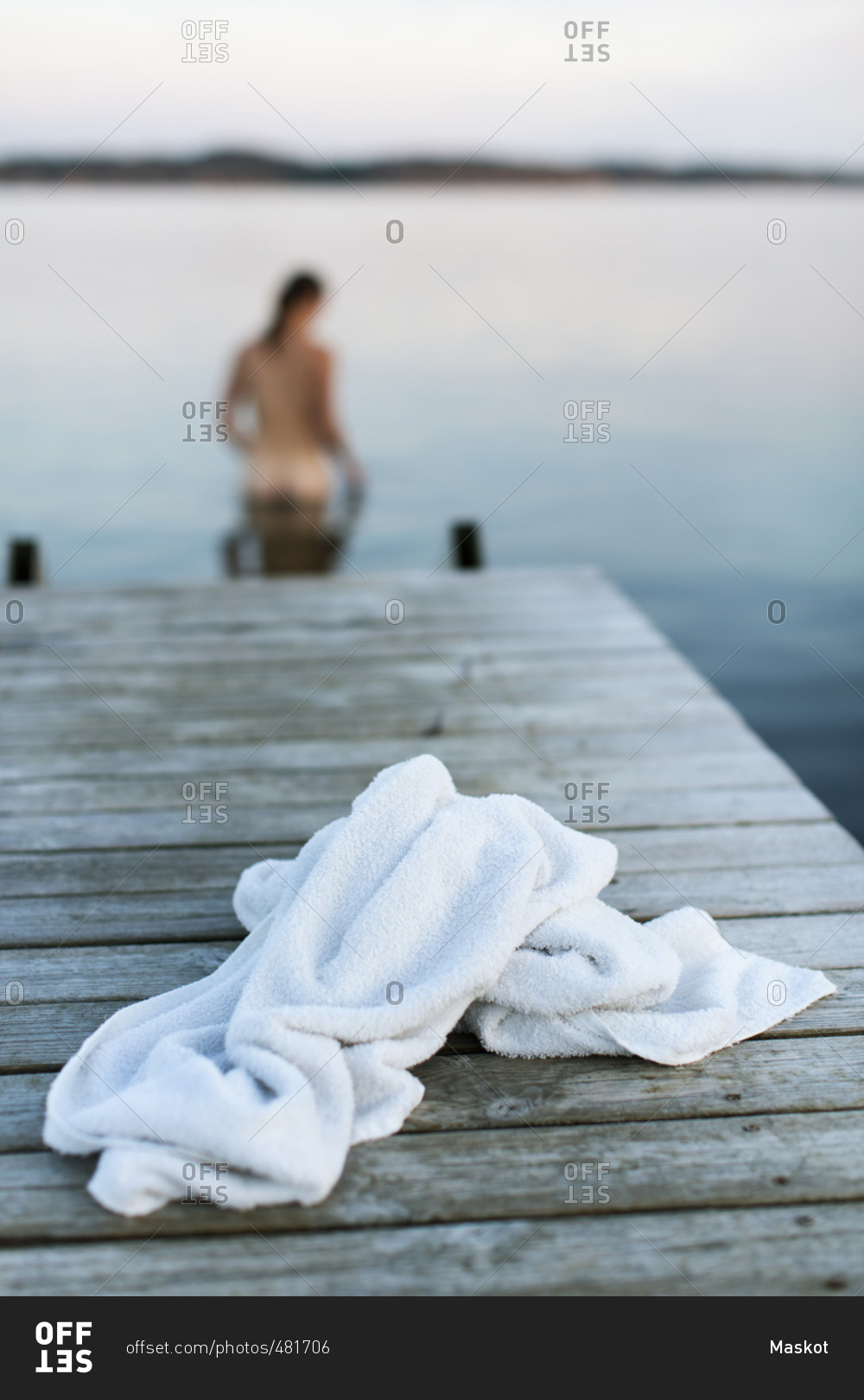 White Towel On Jetty With Naked Woman In Lake Stock Photo OFFSET