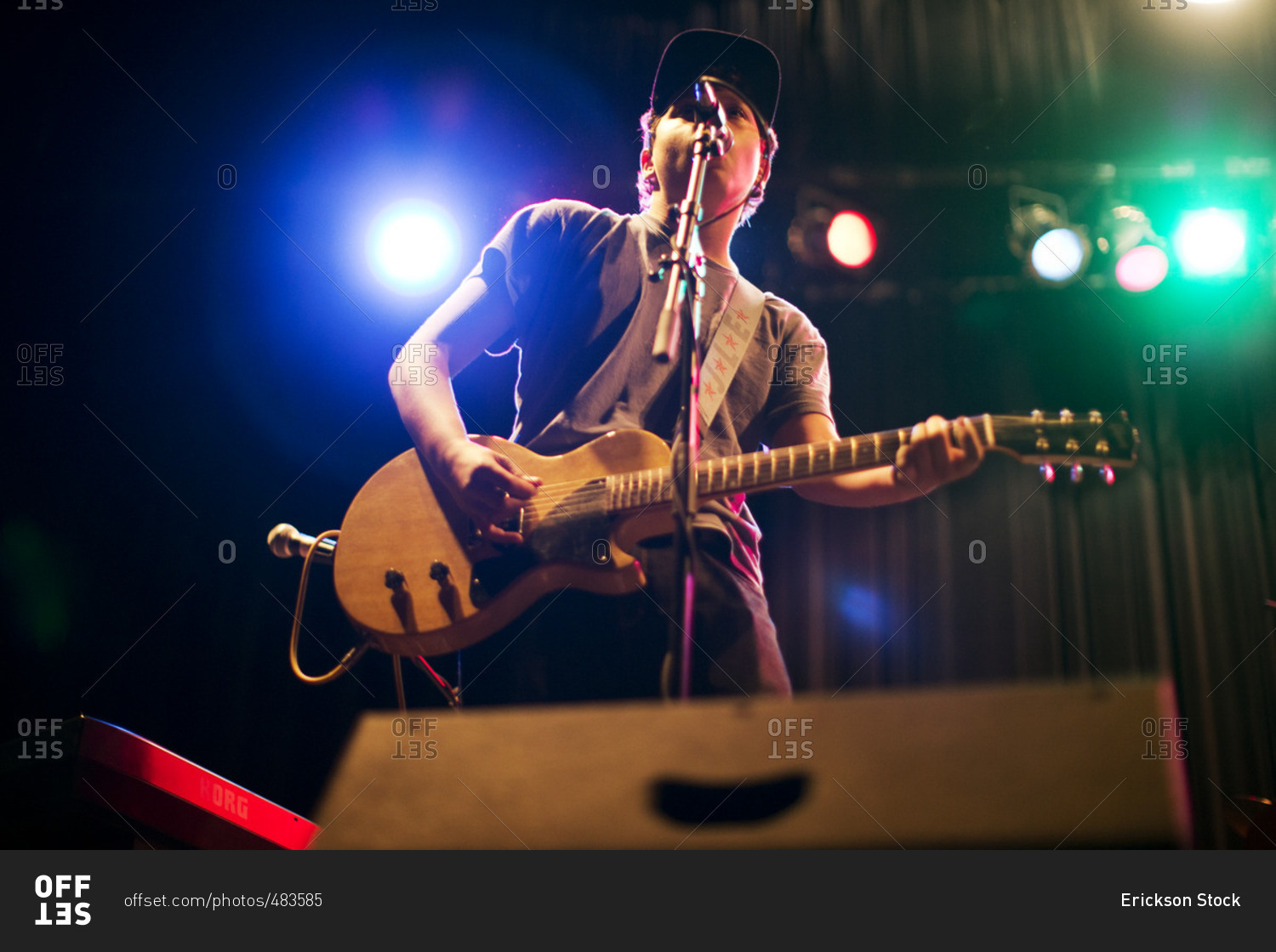 Teenage Boy Singing And Playing Guitar On Stage Stock Photo OFFSET