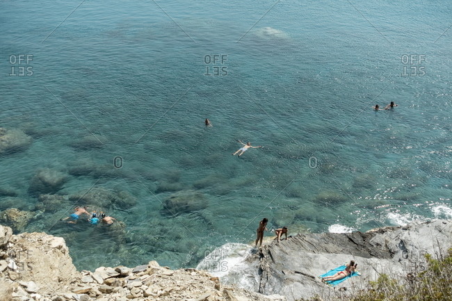 beachgoer,gossips amorgos, cyclades, greece - august 4, 2018: beachgoers at mouros