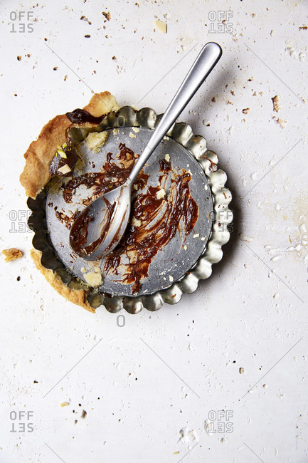 leftovers of decadent chocolate ganache tartlet in baking tin on