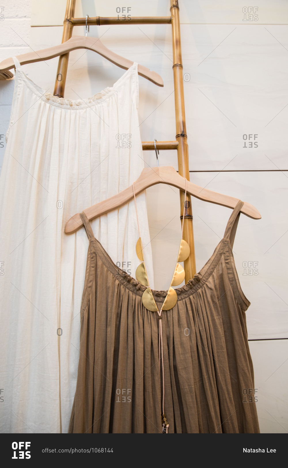 Boho Style Dresses Hanging On Hangers On A Bamboo Ladder In A Boutique