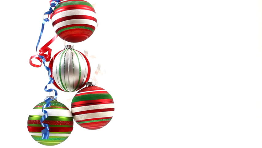 Colorful Christmas ball ornaments, decorated with shiny ribbons, dangle against white background. 1080p