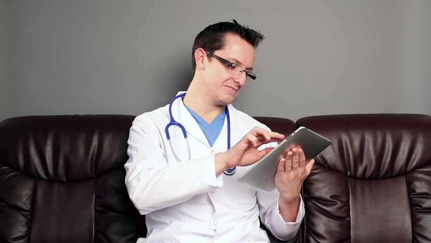 Doctor using tablet computer