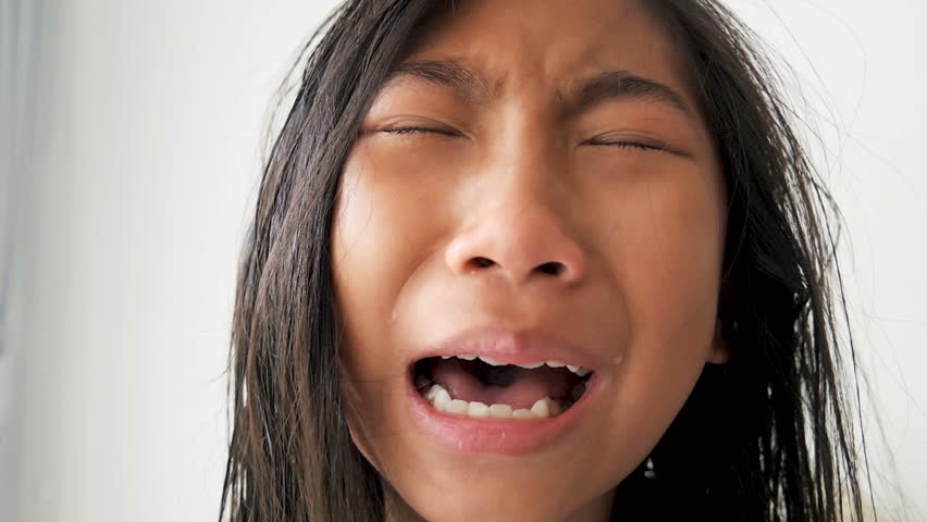 Young asian crying