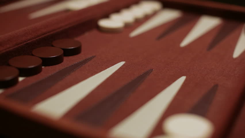 Double fours are rolled and moved by a player in a backgammon game.