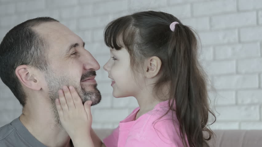 Daddy kisses daughter