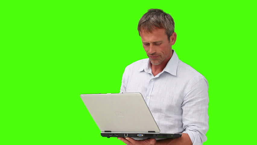  Chromakey footage of a casual man in shirt holding his laptop