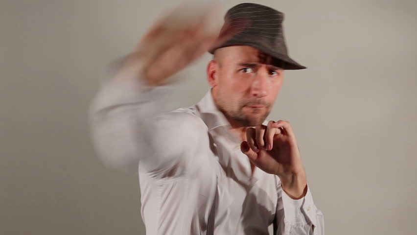 Aggressive young man in a hat and suspenders