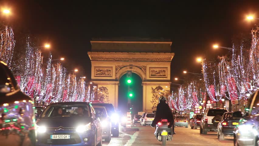 PARIS - JANUARY 1: Cars travel at night on the The Avenue des Champs-Ãâ°lysÃÂ©es toward the The Arc de Triomphe, January 1, 2010 in Paris, France. The Champs-Elysees ends at the Arc de Triomphe, the most monumental of all triumphal arches. The Arc de Triomp