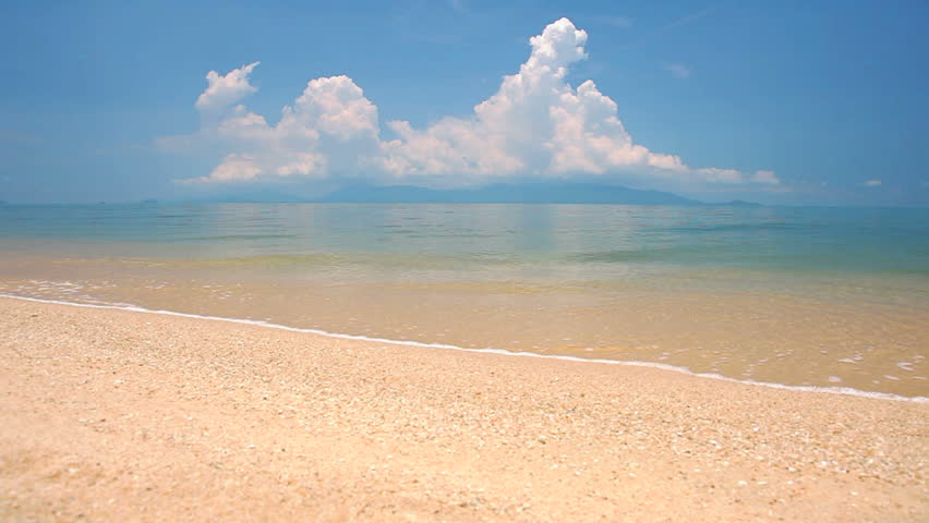 waves landing on sandy beach