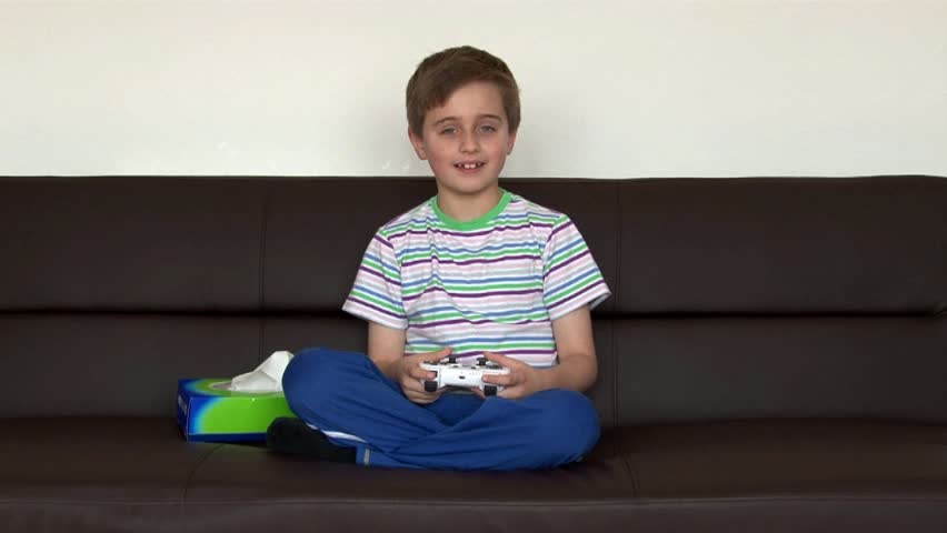 Young boy gets the sneezes while playing video games 