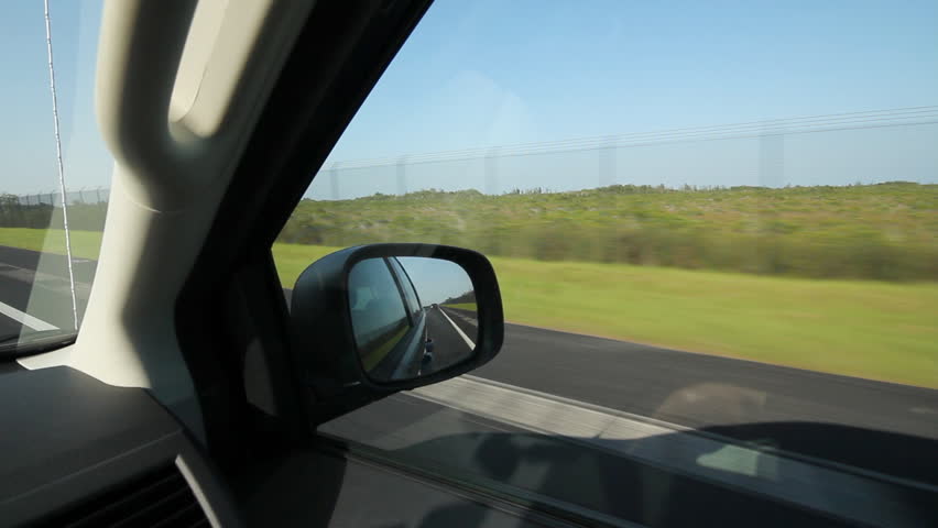Driving in Florida. Fence and mangroves. Driving on a highway in the Florida Keys. Passing fence and mangroves.  