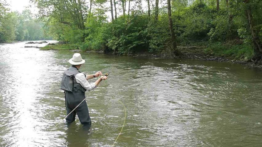 Man fishing trout in river