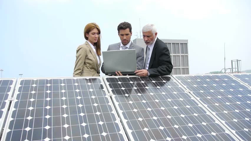 Business people standing by solar panels