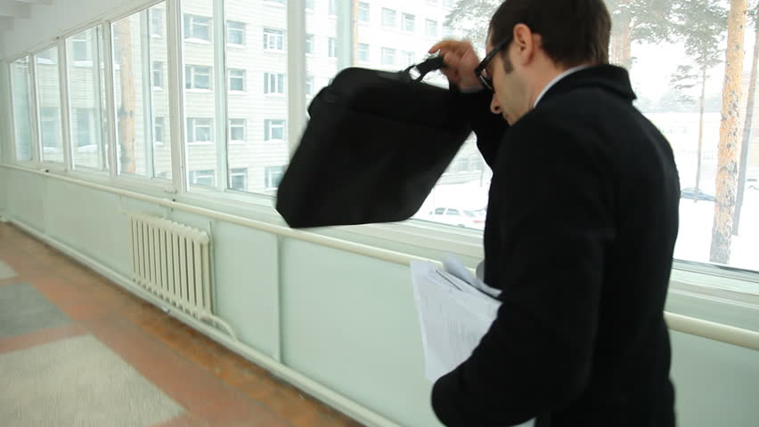 man walking quickly along the corridor. Hurry
