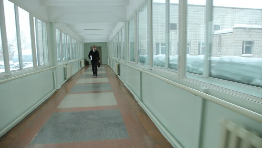 man walking quickly along the corridor. Hurry