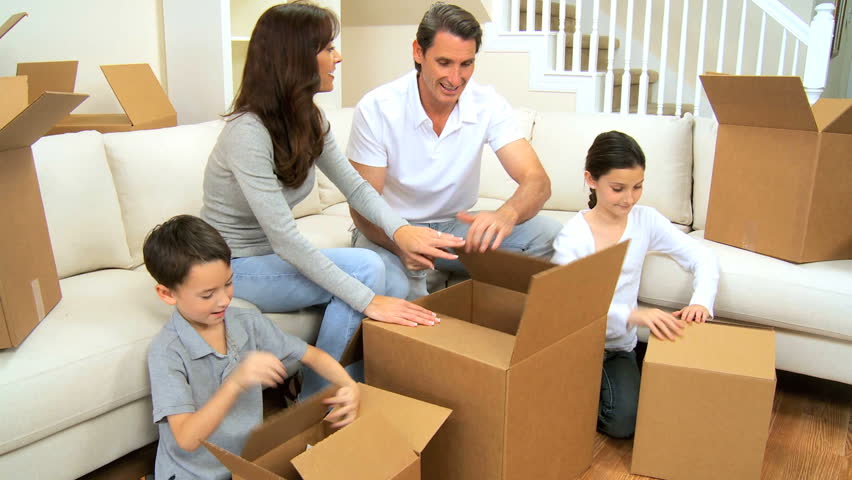 Young family unpacking their possessions following a house move
