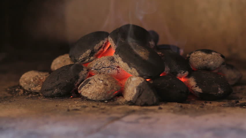 Closeup of hot wood briquettes in the garden grill