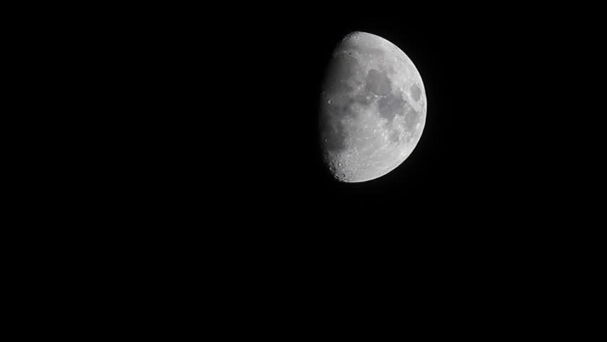 half moon with some clouds moving