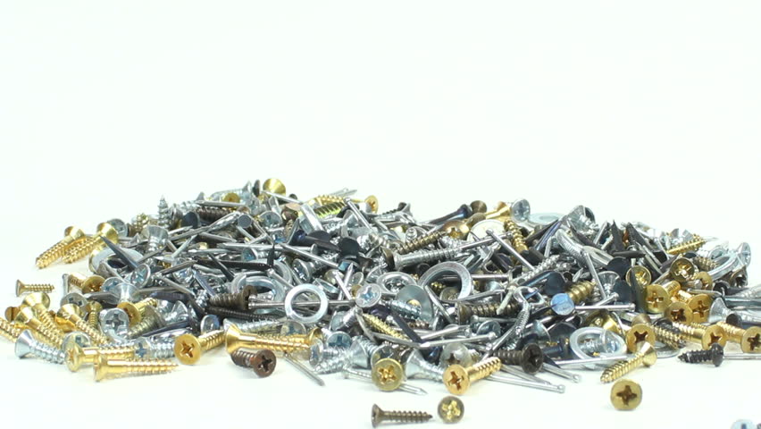 Magnet swings across pile of assorted nails, screws and washers, attracts a large clump, lifts it, twirls around, slowly descends, drops onto pile. Magnetic properties concept. 1080p