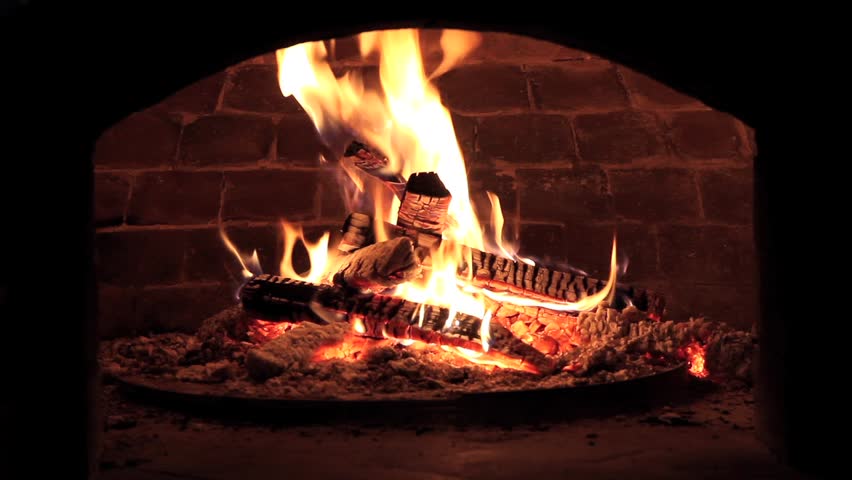 Fire burning in a forno (Pompeii) brick pizza oven.